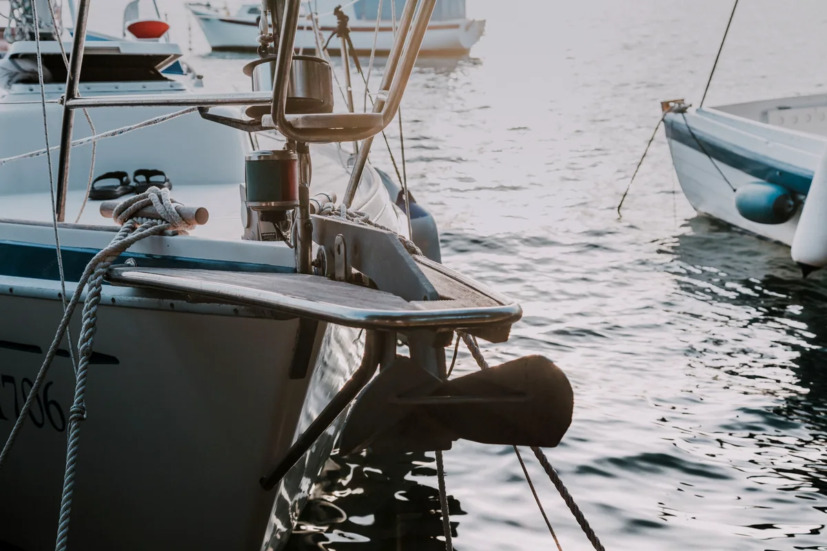 White boat transom and swim step in a marina.