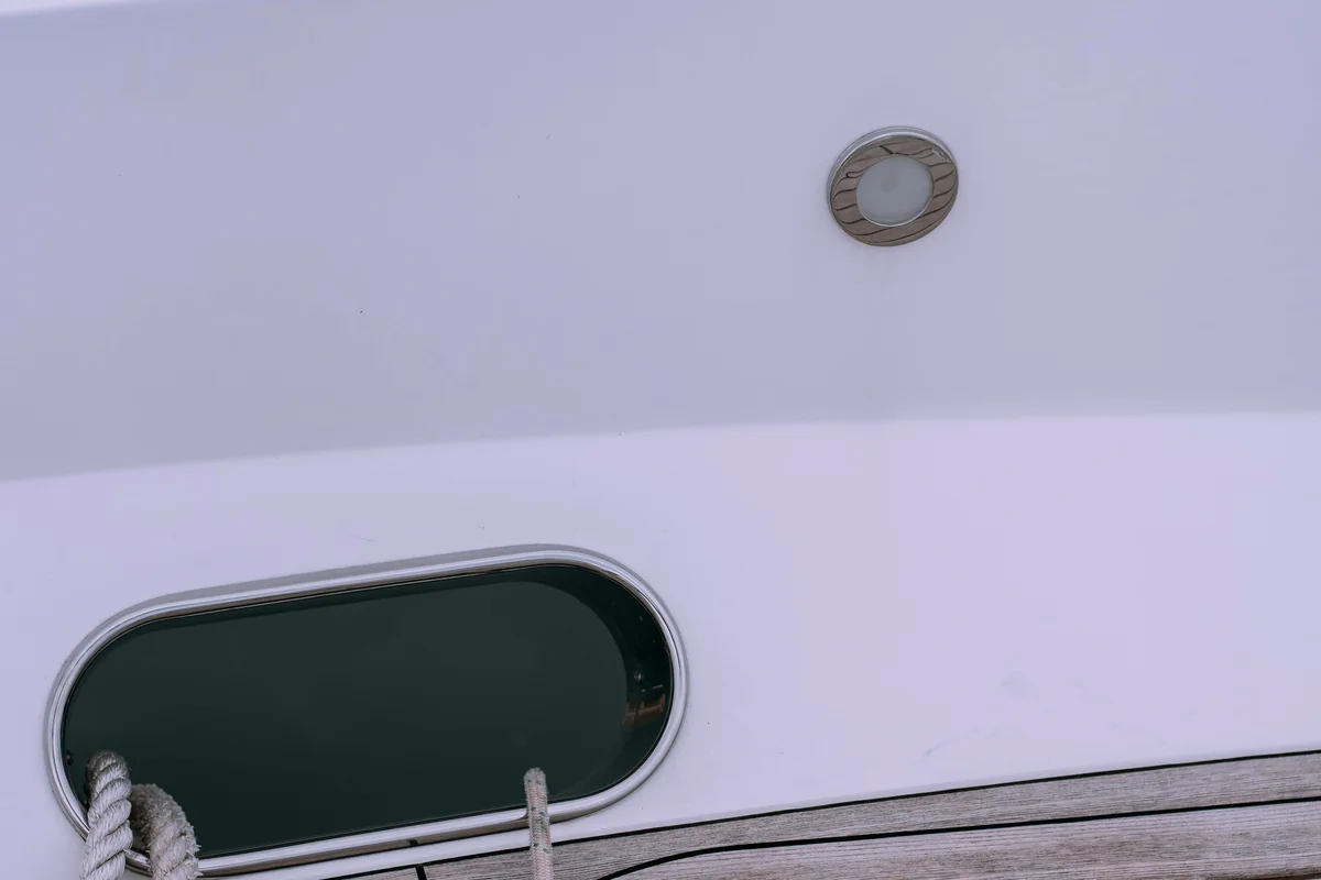 Close deck detail with a hatch opening, rope, and routed panel lines.